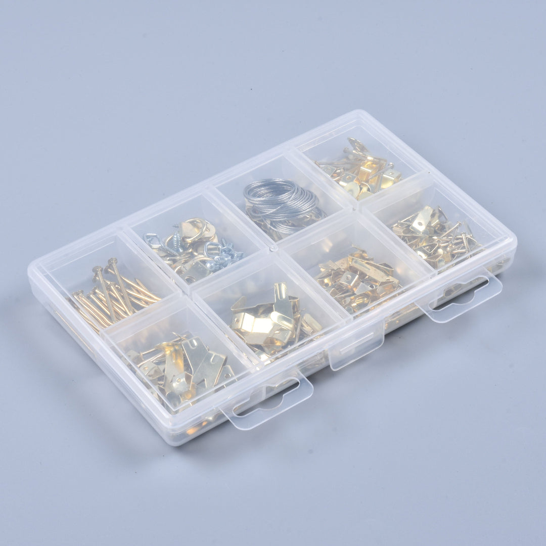 Clear plastic organizer box with compartments containing small metal components on a light gray background