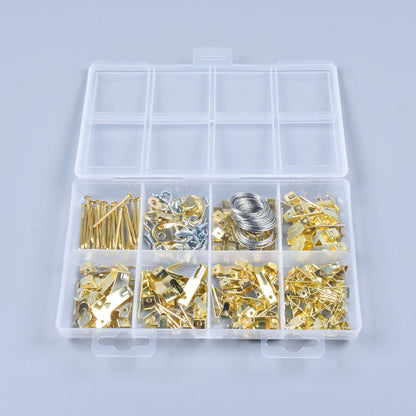 Assorted metal components in a clear plastic box on a light gray background