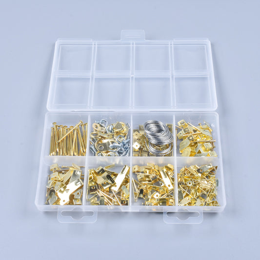 Assorted metal components in a clear plastic box on a light gray background